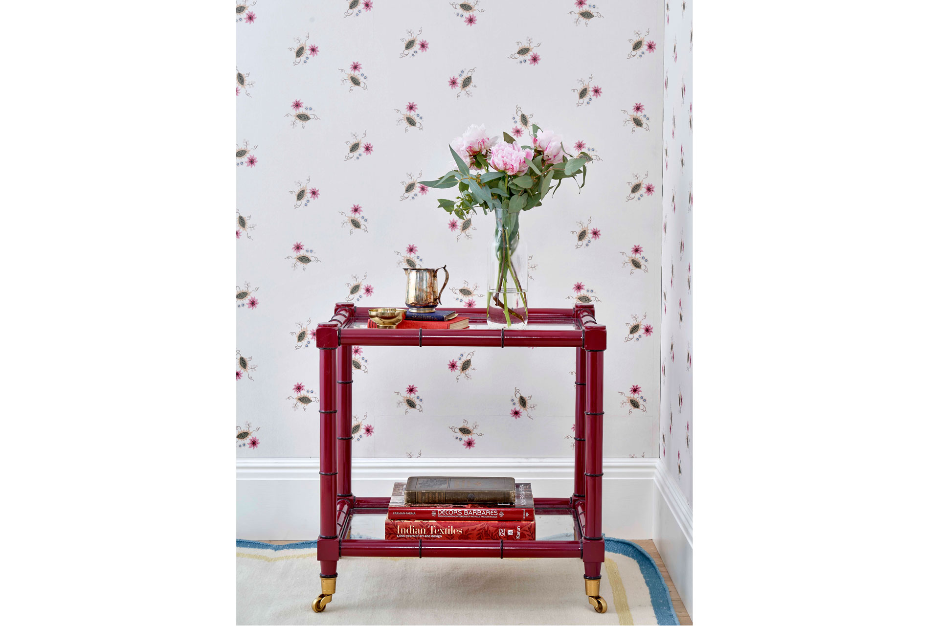 Salvesen Graham Floral Sprig Wallpaper with a red table and flowers on top