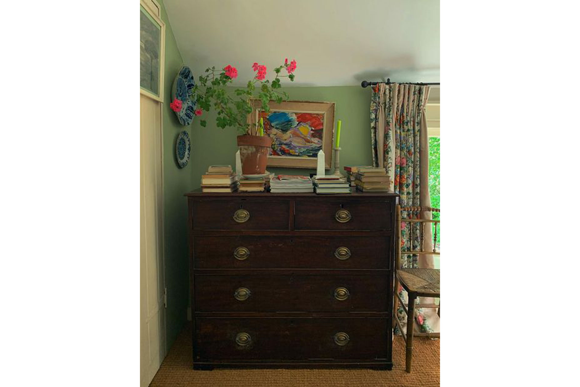 books stand on a chest of draws in a spare room by Sean Antony Pritchard