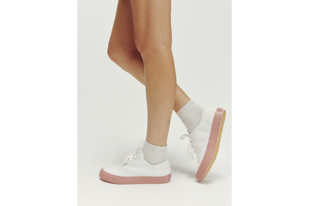 Close up of someone wearing white trainers