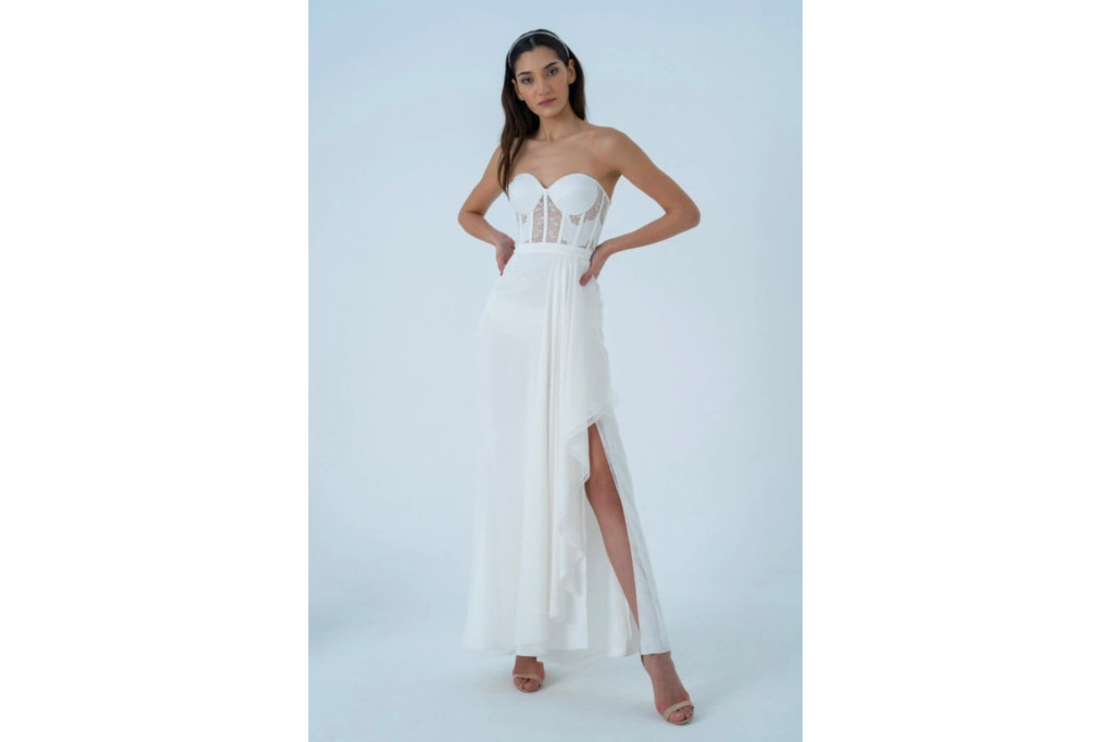 Model in white bustier dress with slit