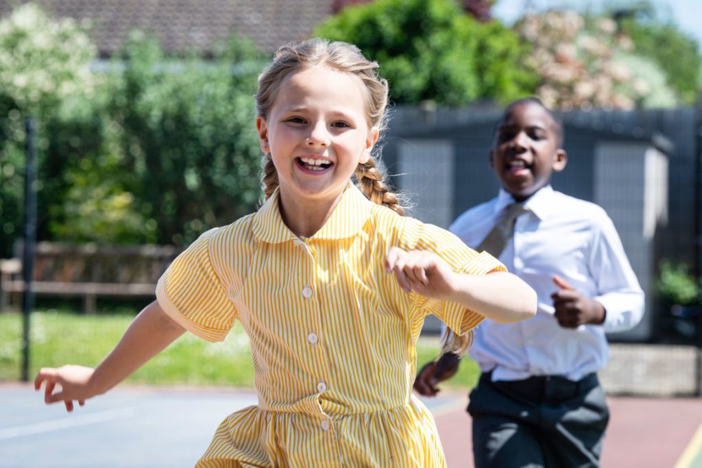 Children smiling and running together