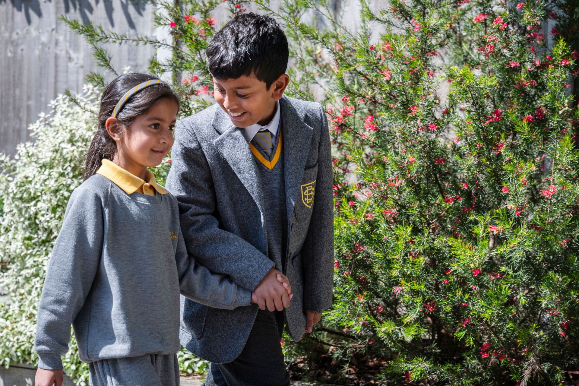 Young boy and girl walking holding hands