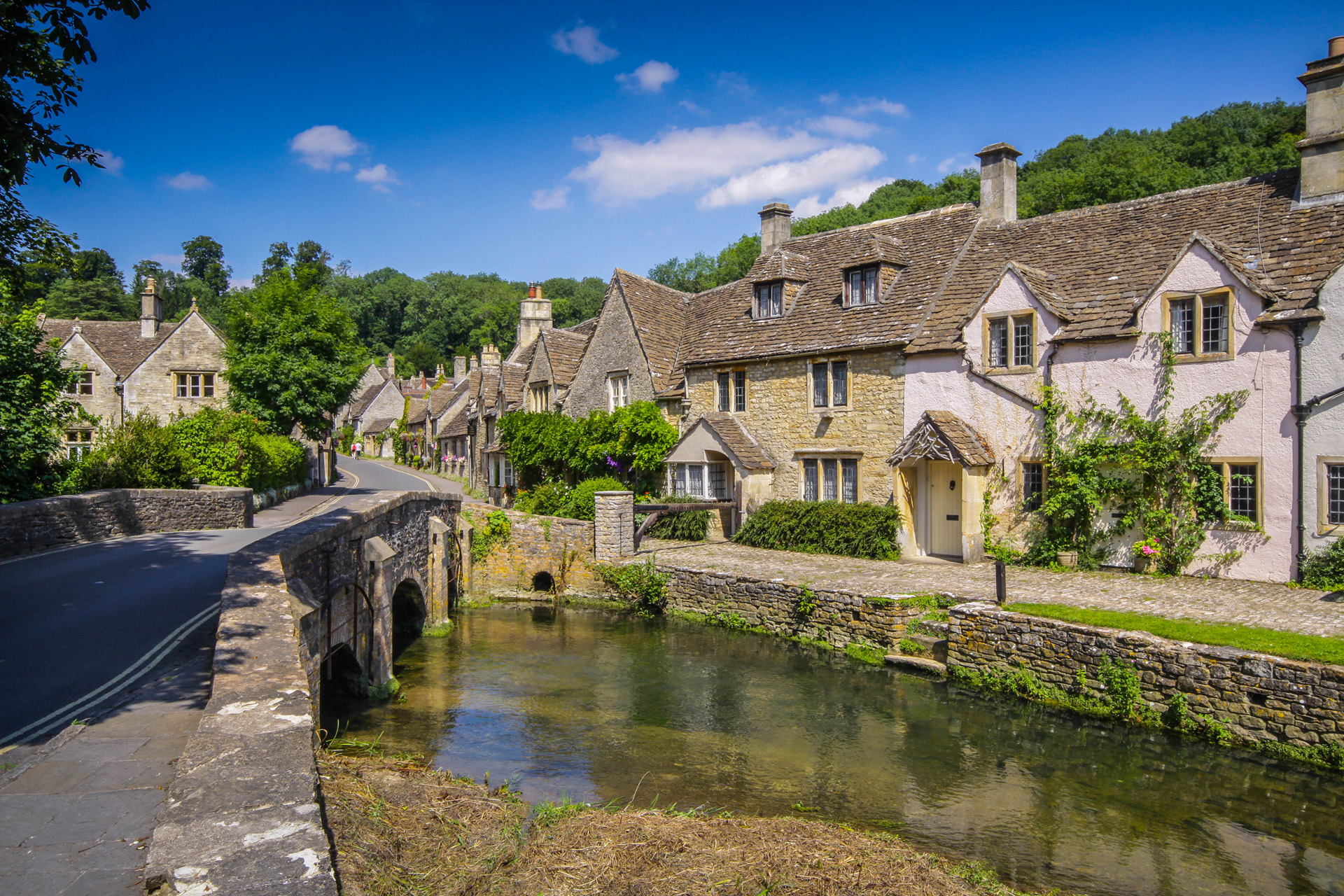 A view along he village main street from the bridge with river in the foreground.