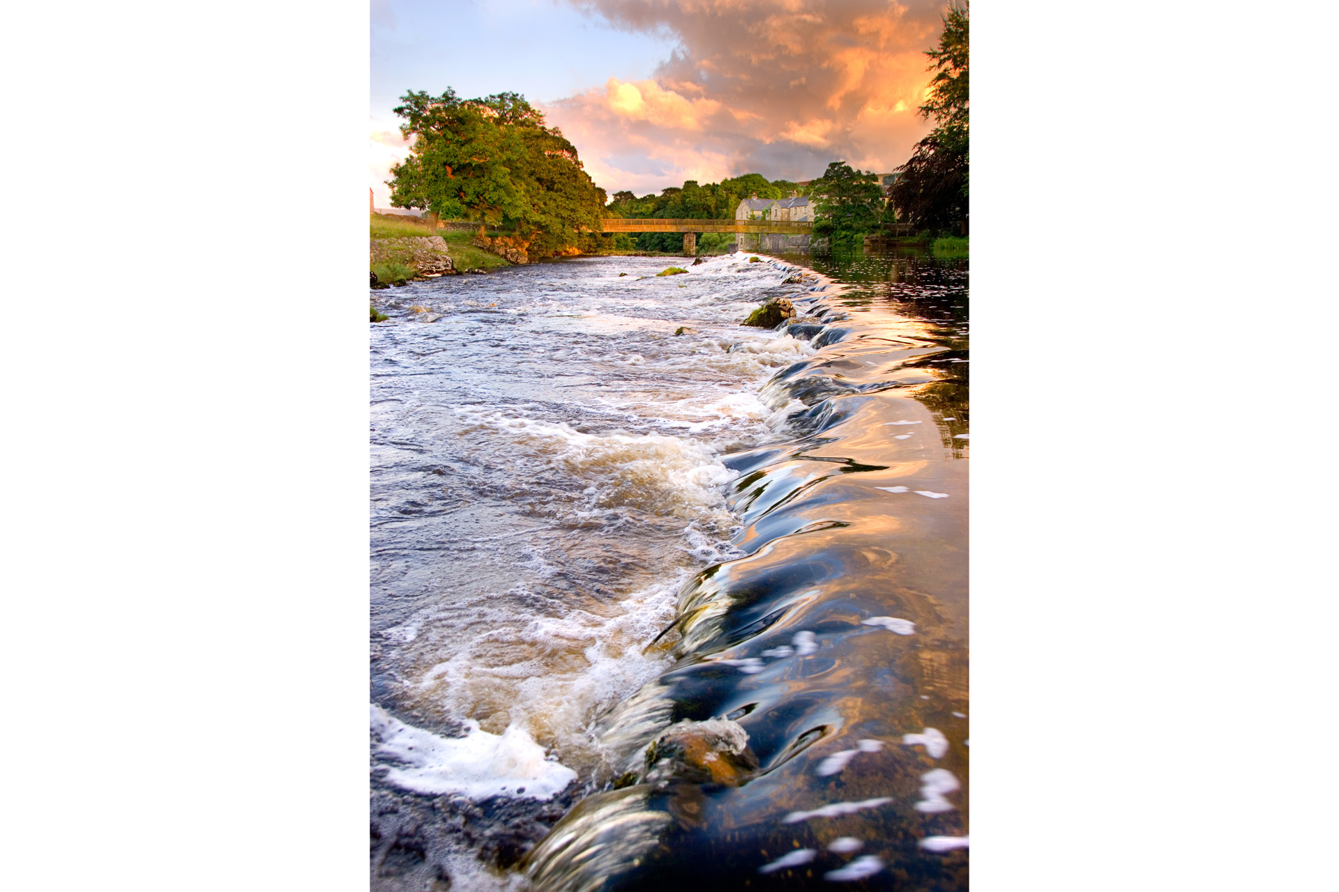 Water running over weir at evening at Grassington, Yorkshire Dales National Park, North Yorkshire, England