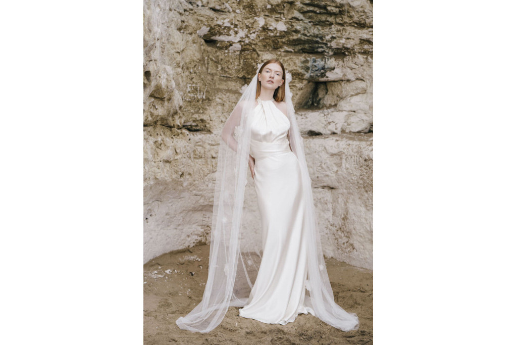Model in wedding dress on the beach