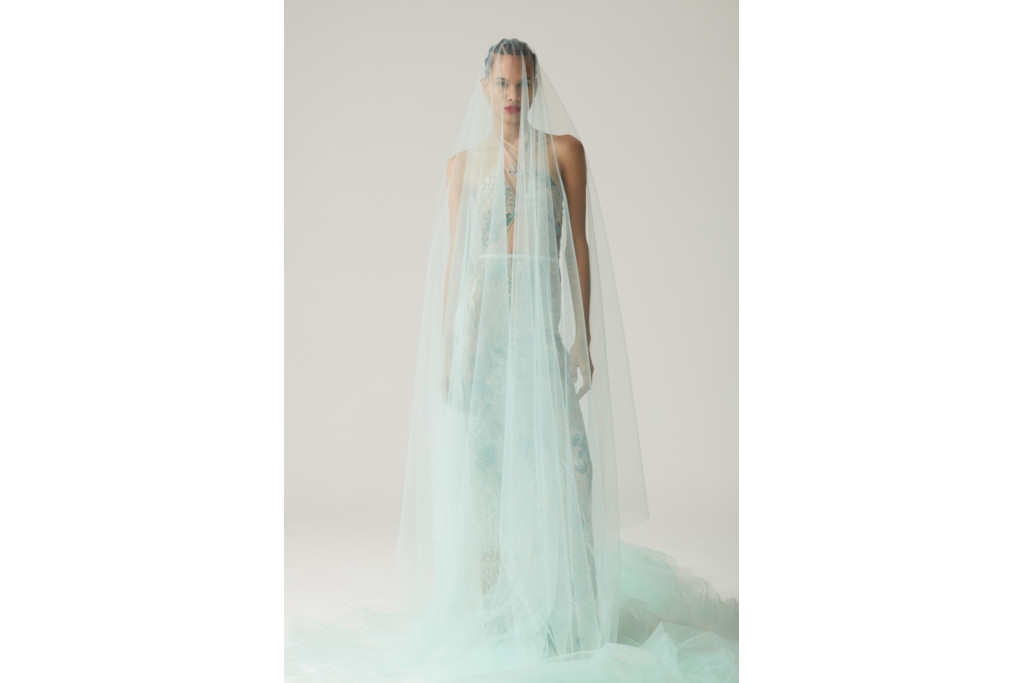 Model stood in blue veil and sheer dress