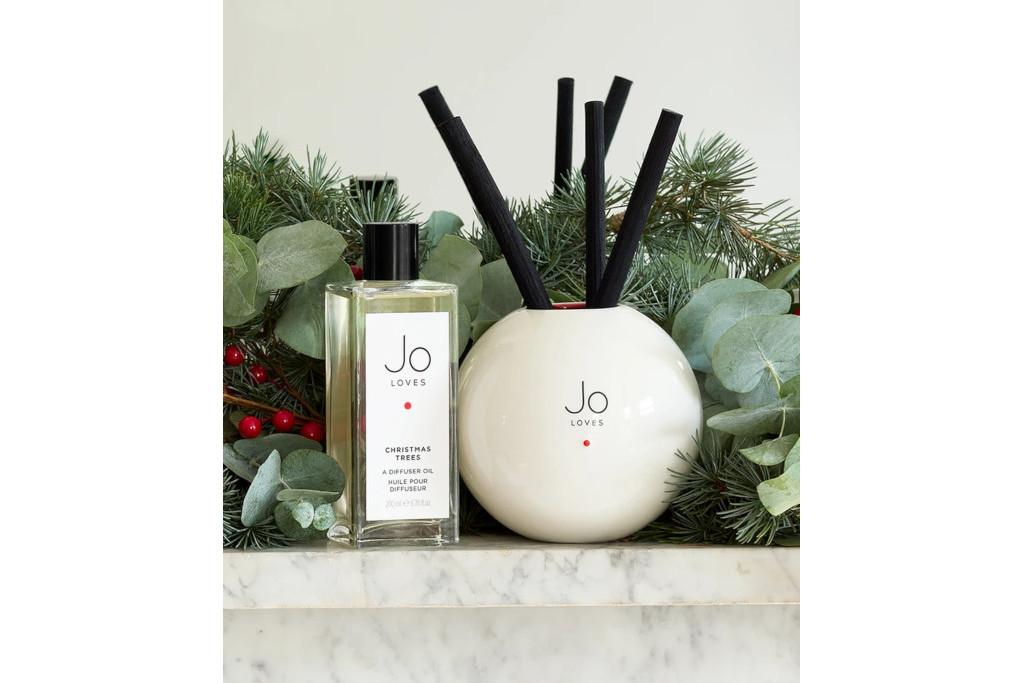 Diffuser and bottle on marble counter with garlands