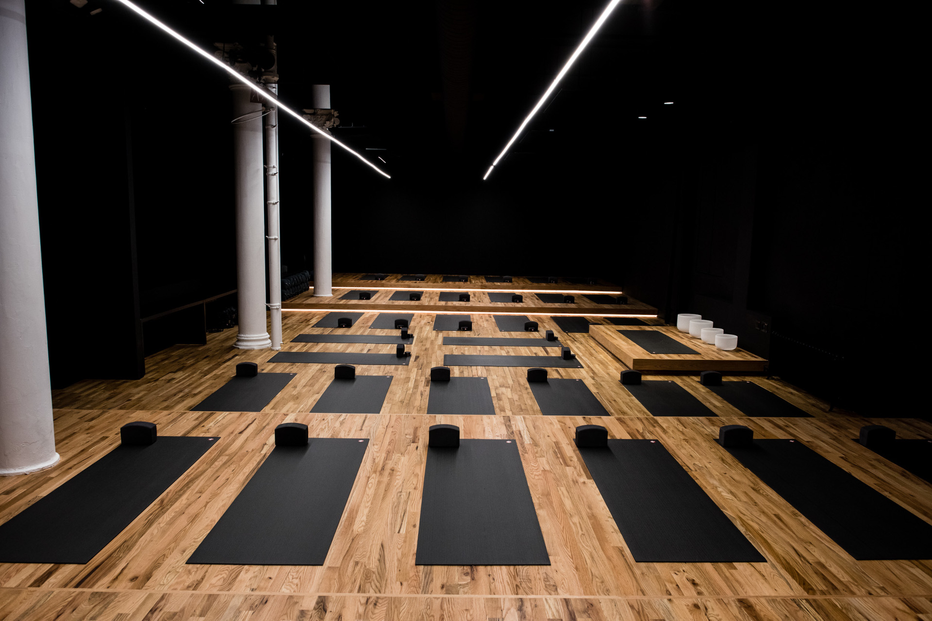 Yoga studio with black mats and walls