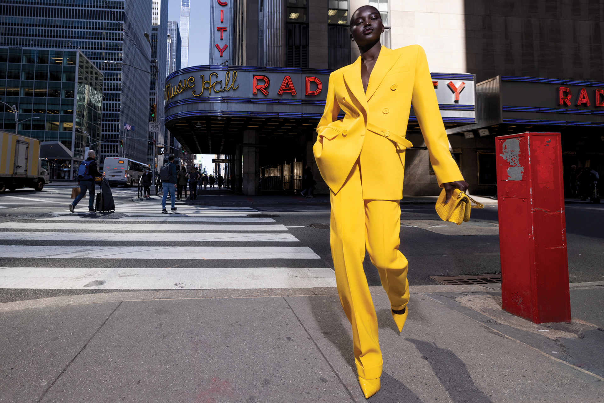 Model in yellow suit walking through New York City