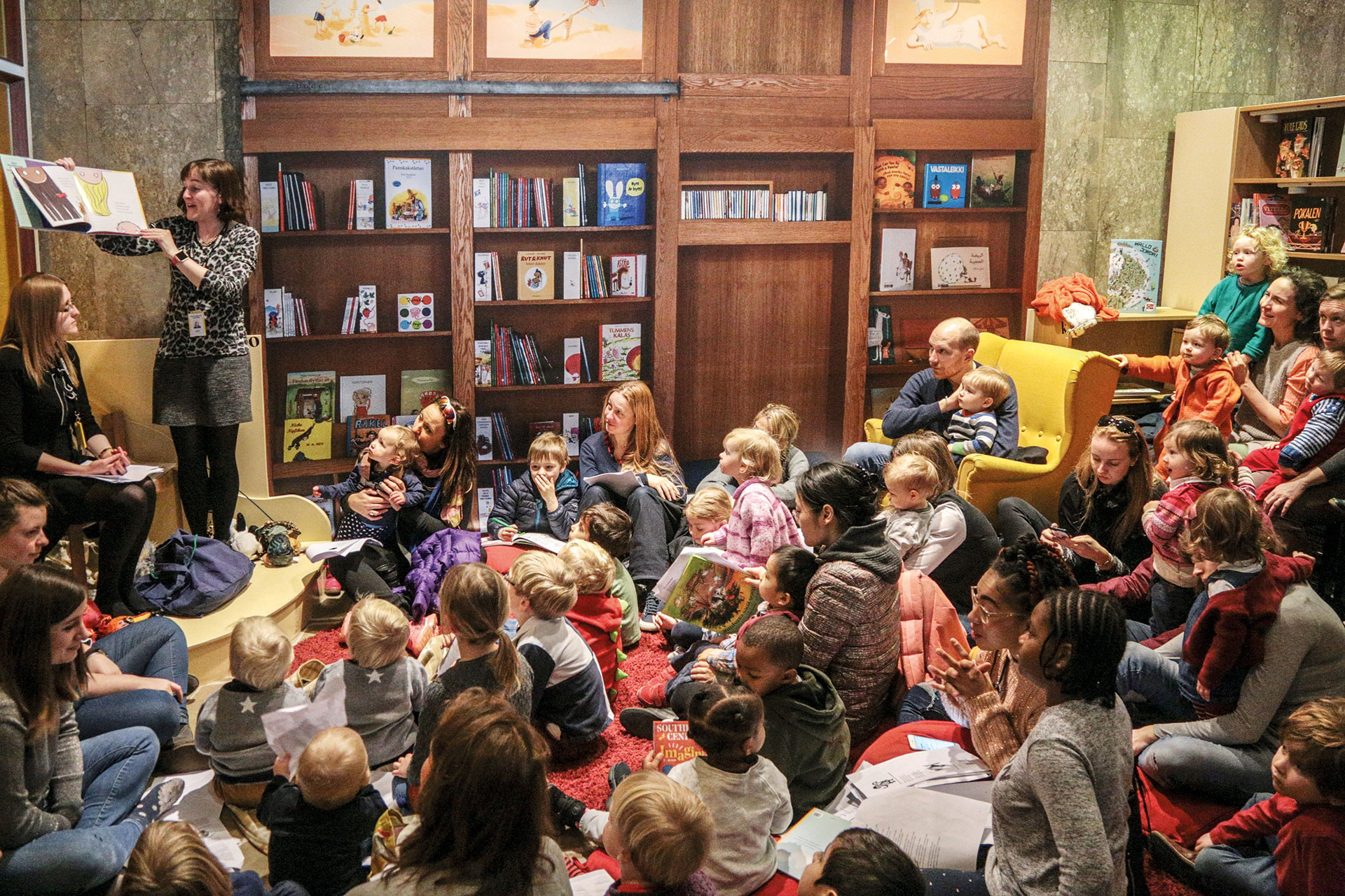 Lots of children sitting in a library