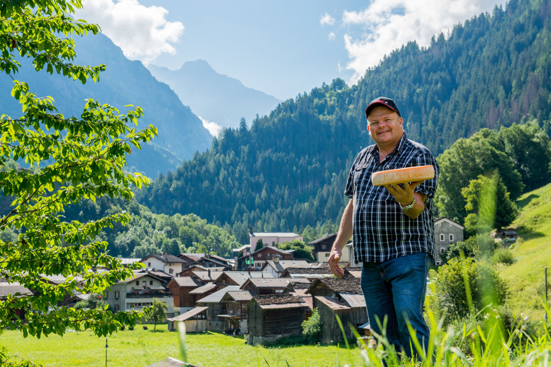 Farmer holding a wheel of cheese