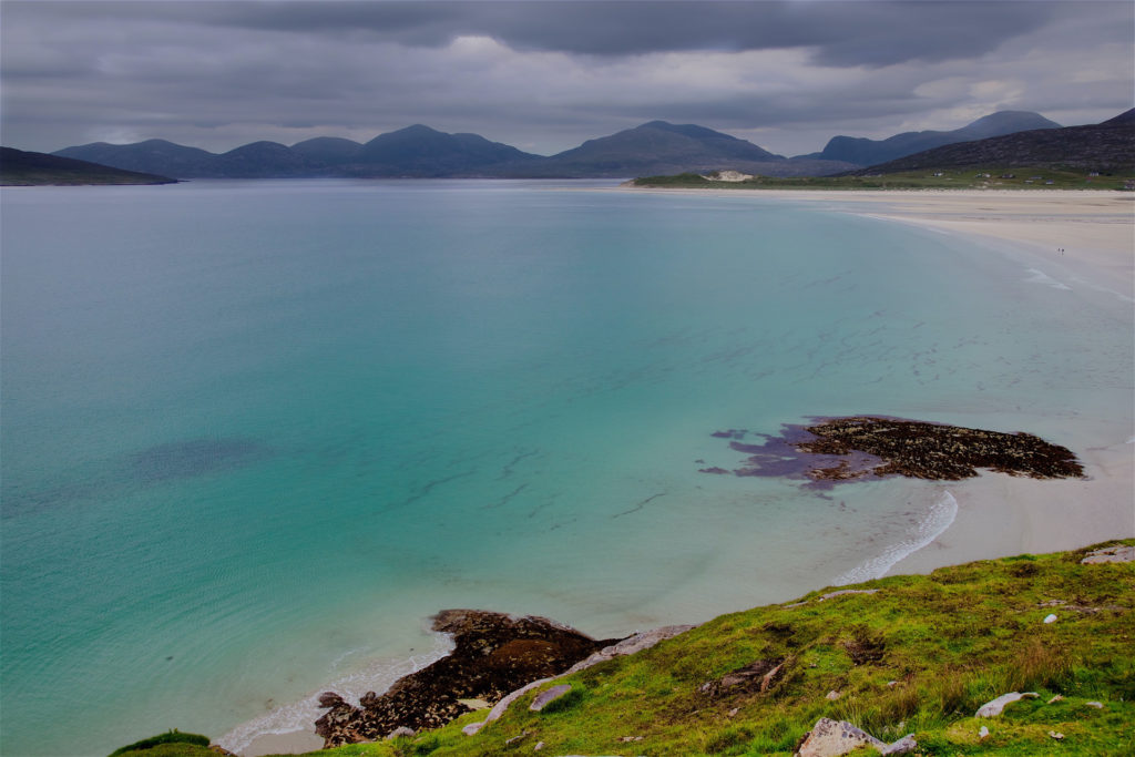 calm blue waters with a misty sky