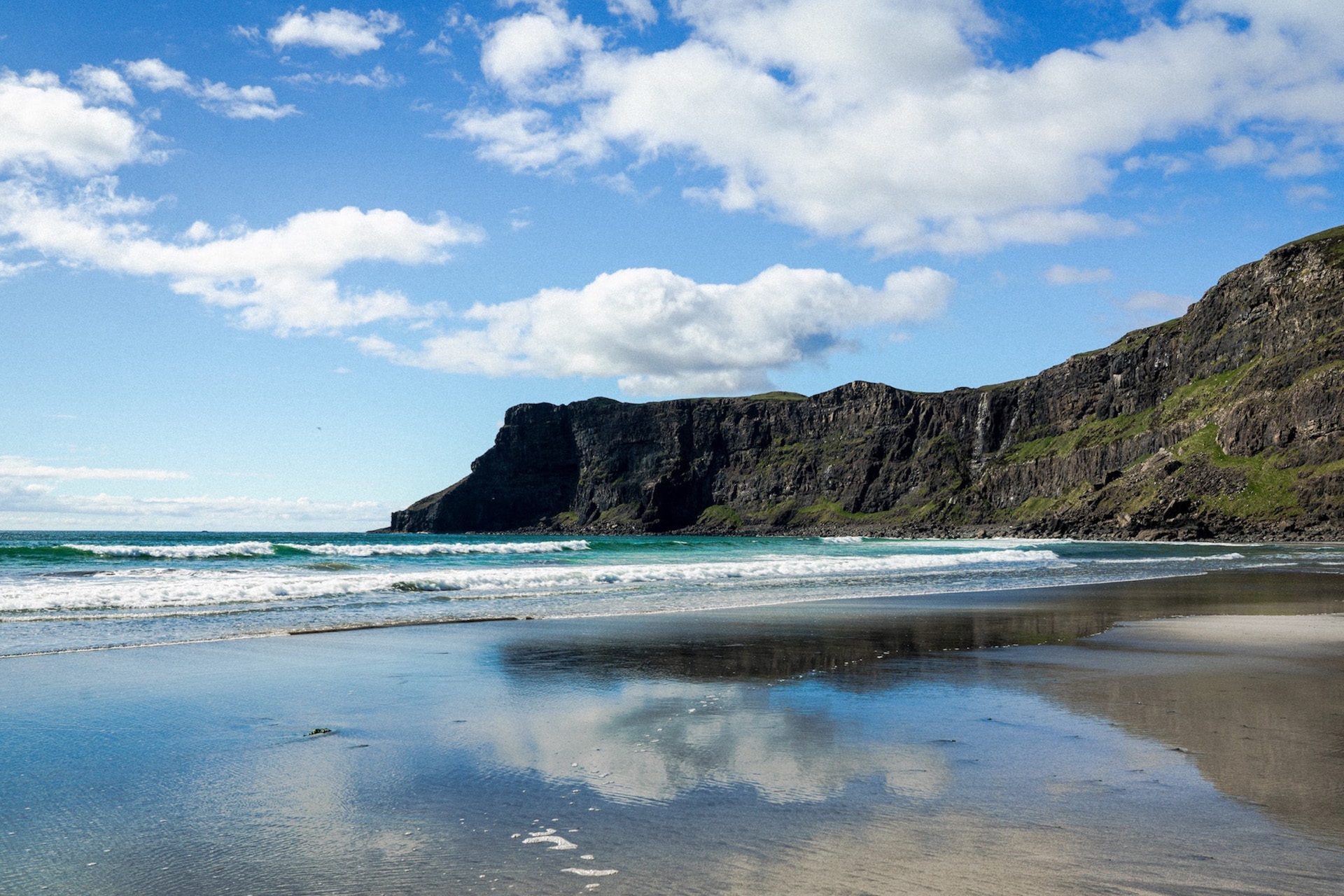 A dark cliff leading out to the sea