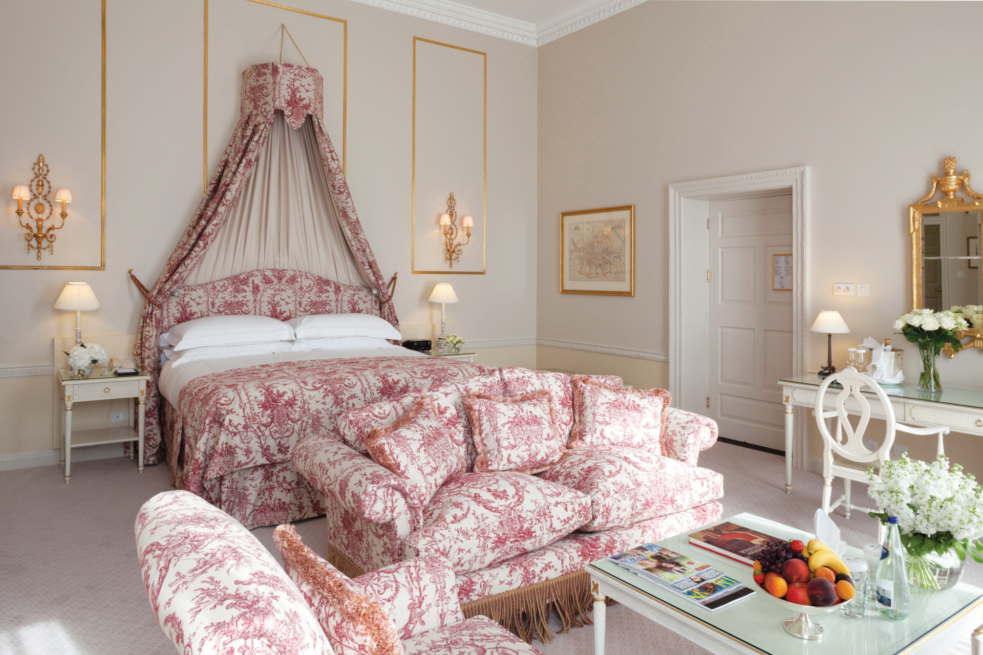 Ornate bedroom with red bedding and furniture
