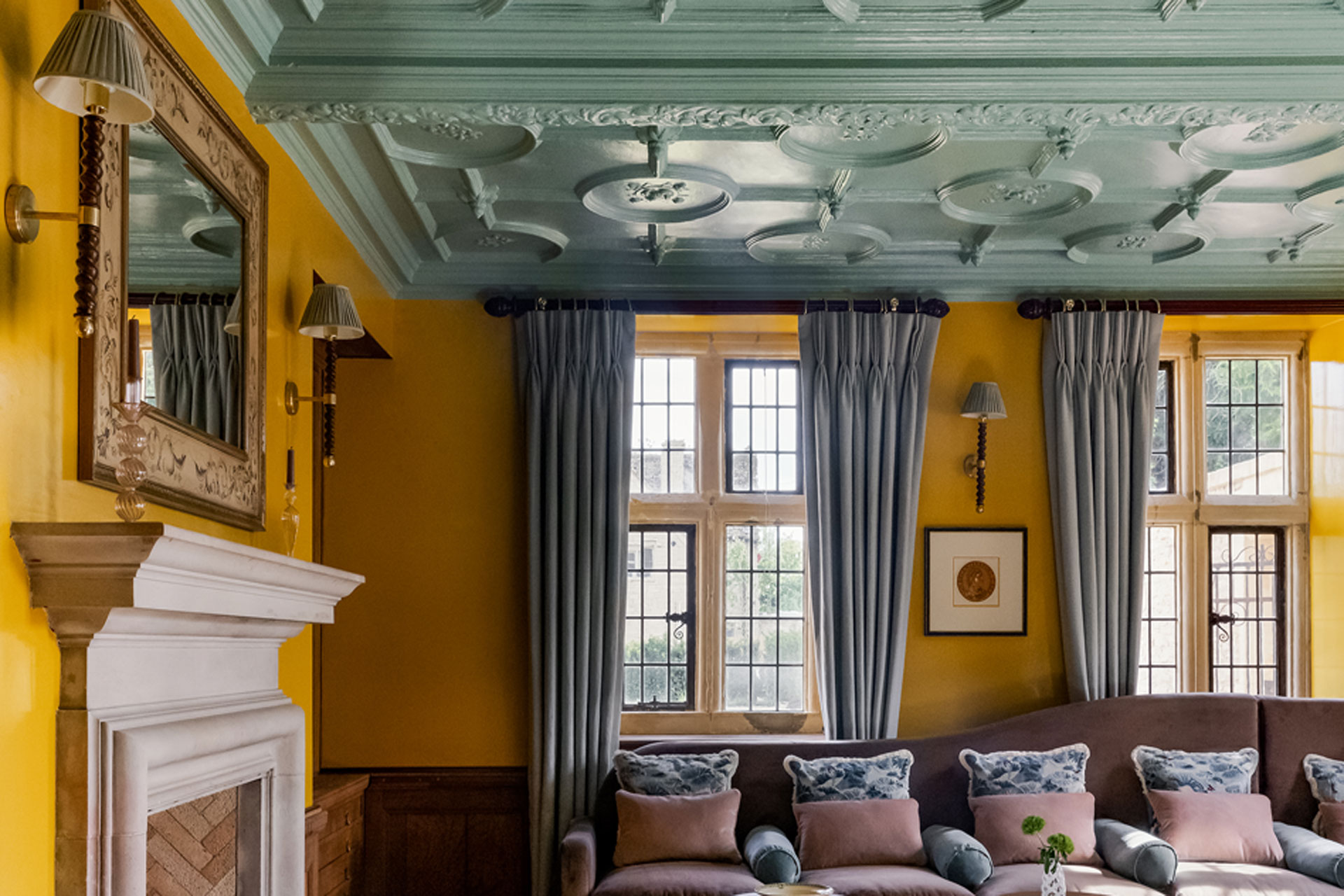 The living room of Kin House, with a green ceiling, yellow walls, and it's designed by Barlow & Barlow