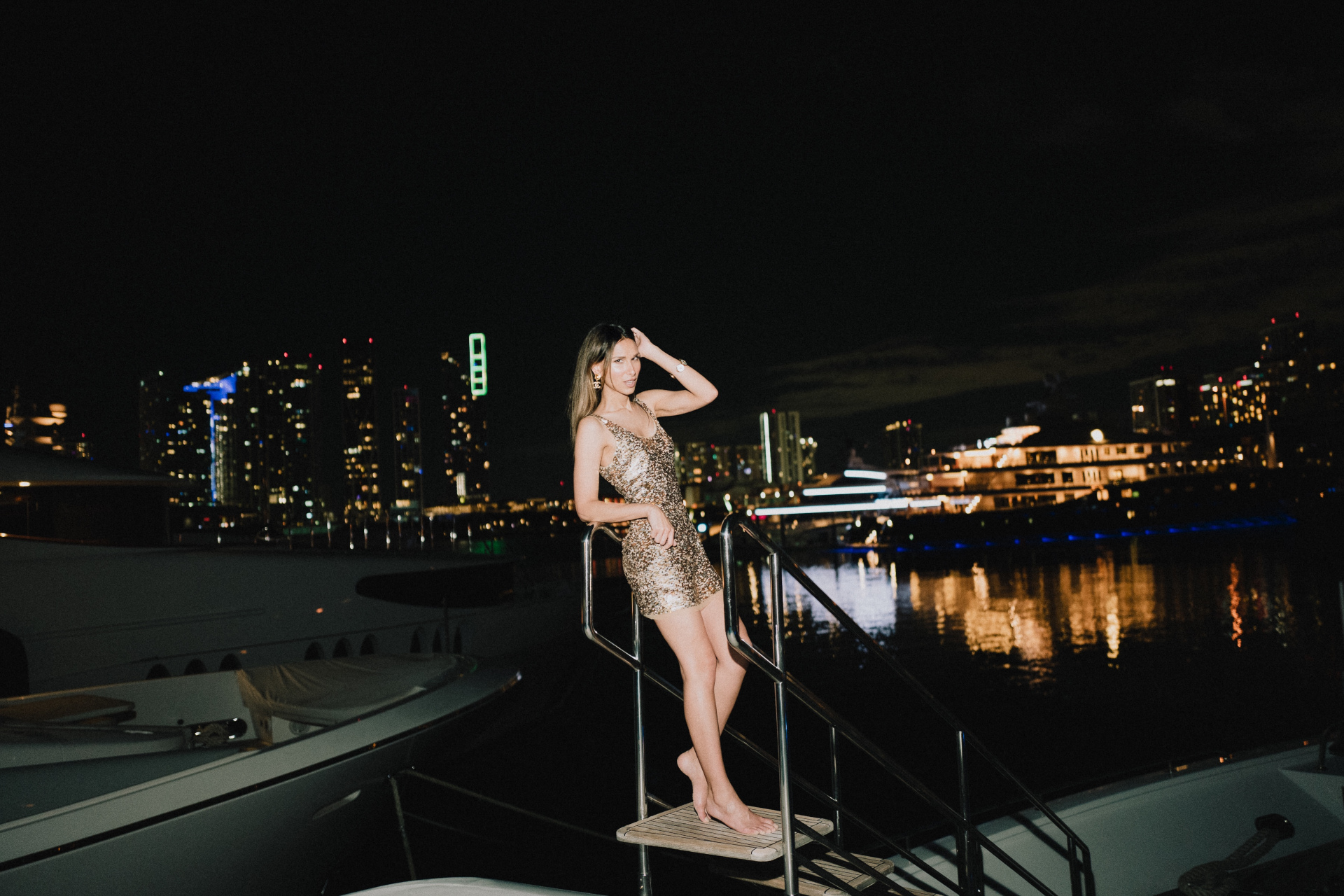 Isabella Charlotta Poppius stood on a dock in a sequin mini dress at night