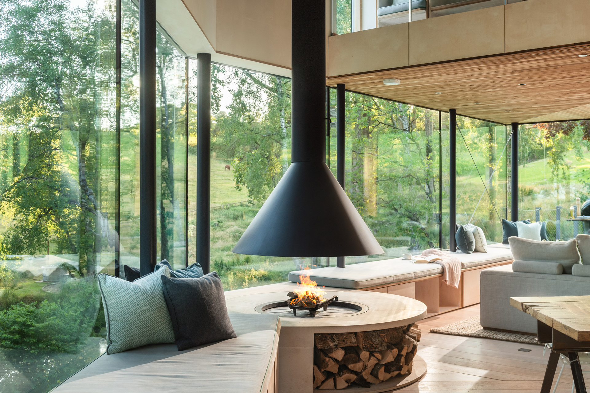 a large fireplace with trees through the window