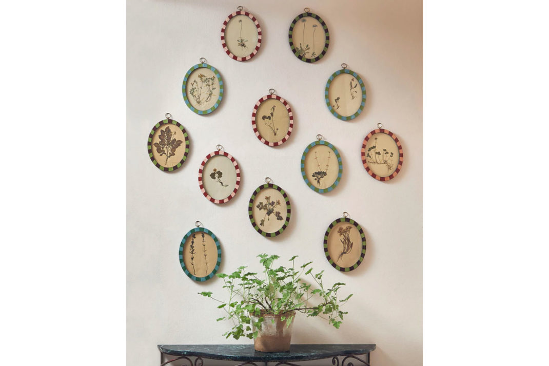 a collection of oval frames in stripey and checked lacquer framing by Matilda Goad