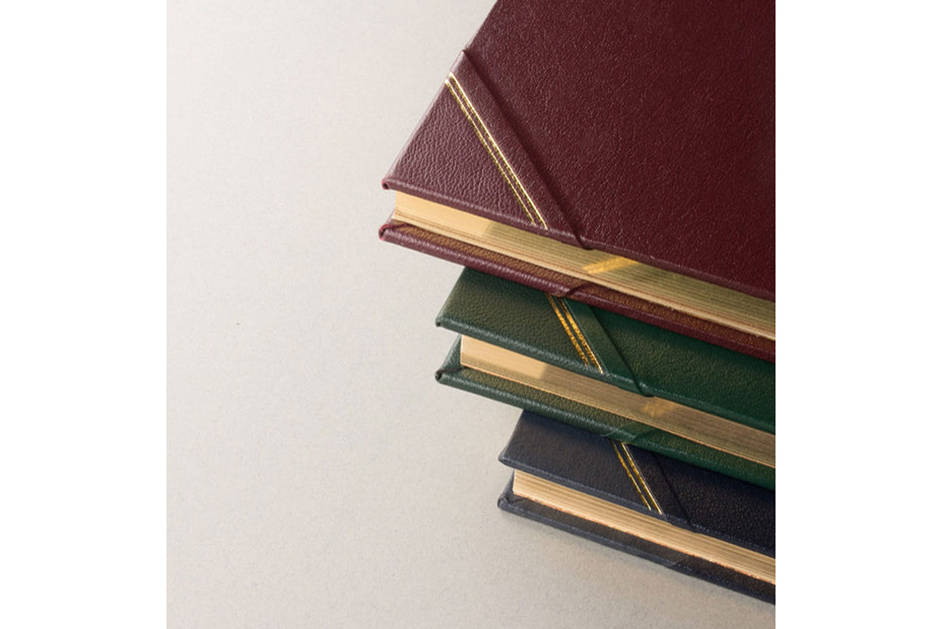 a close up of a gold paged House Guest book by Mount Street Printers