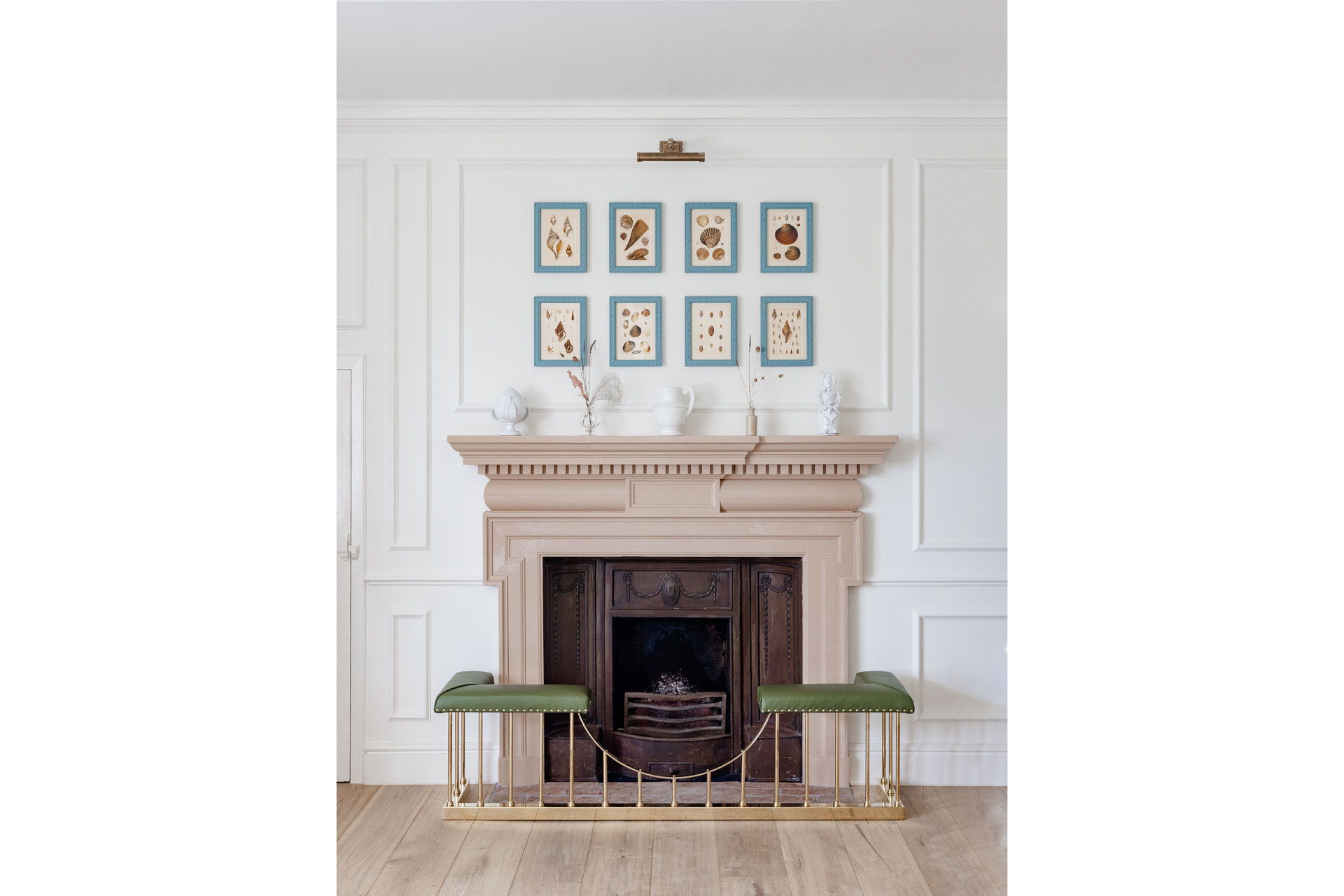 a pink chimney with green seating, and paintings with blue frames, designed by Barlow & Barlow