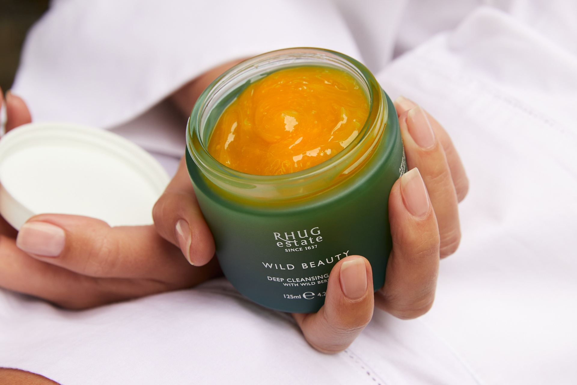 Green tub of orange skin cream