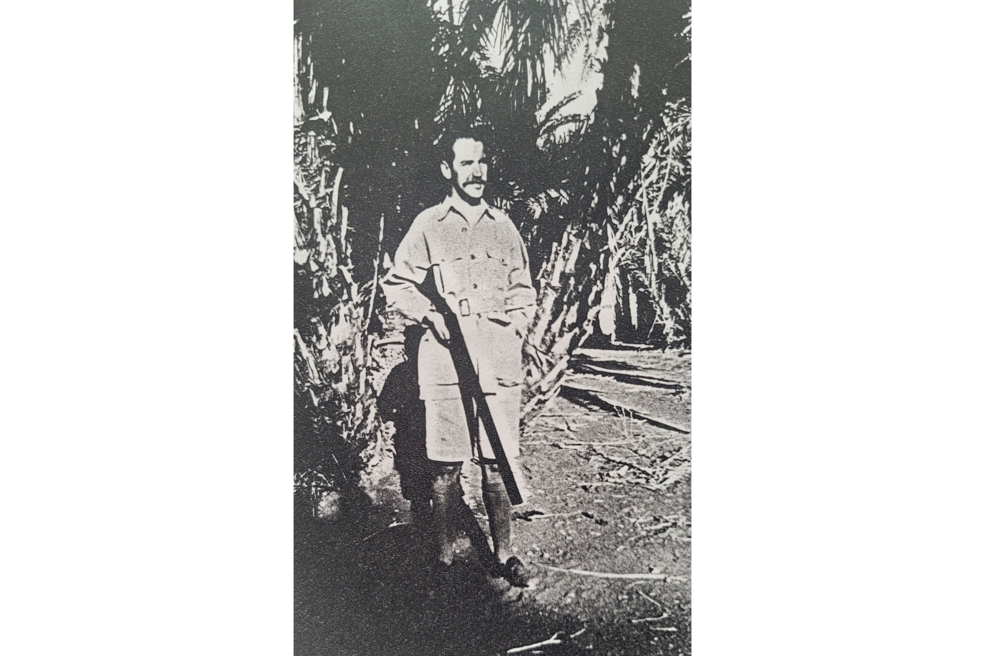 Black and white photo of man holding a gun