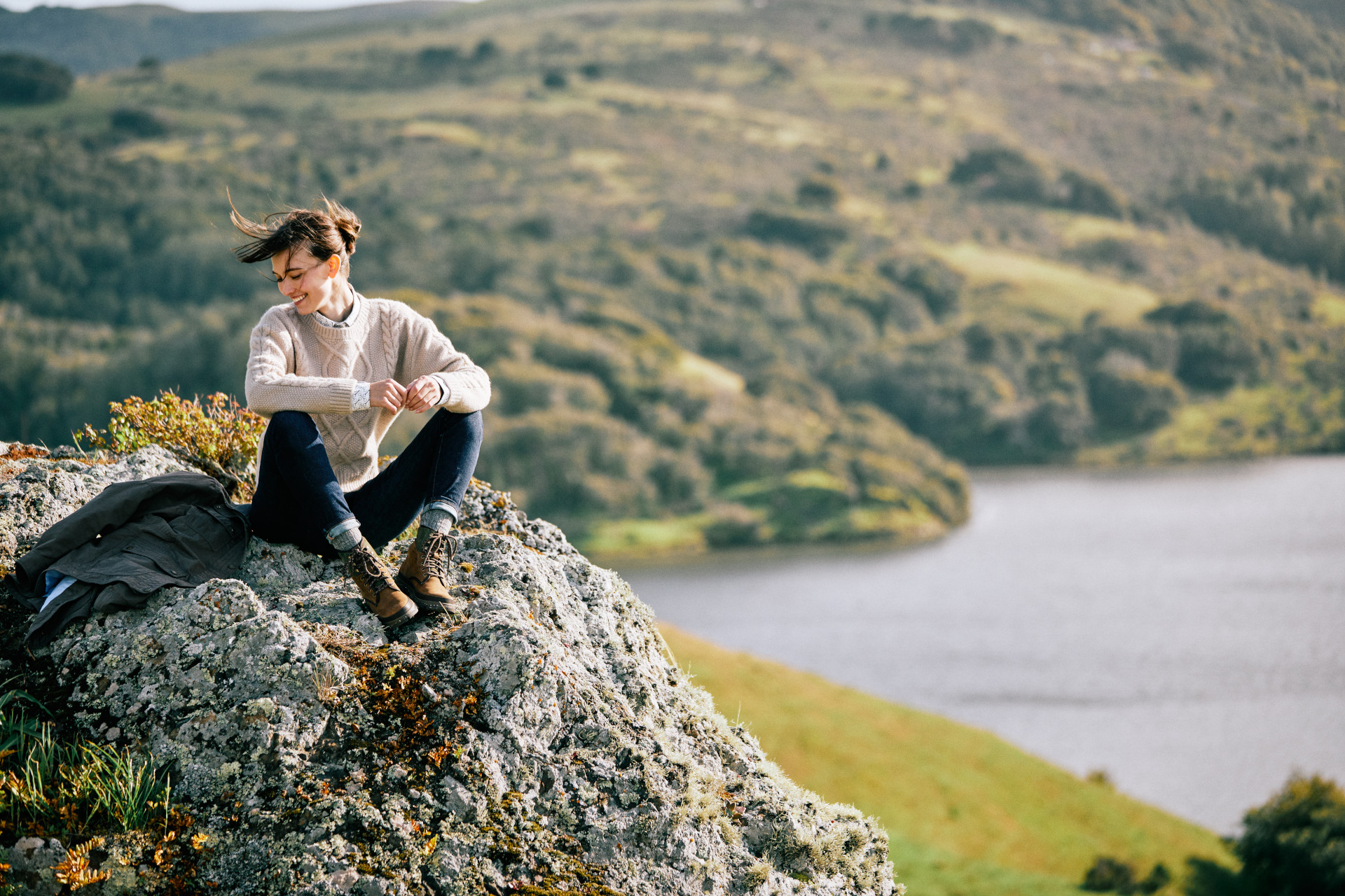 Woman sitting on a rock in countryside