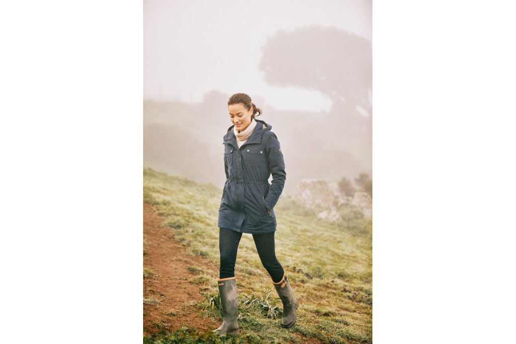 Woman walking through misty valley