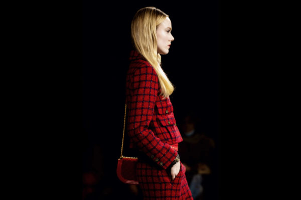 Model in red suit walking the runway
