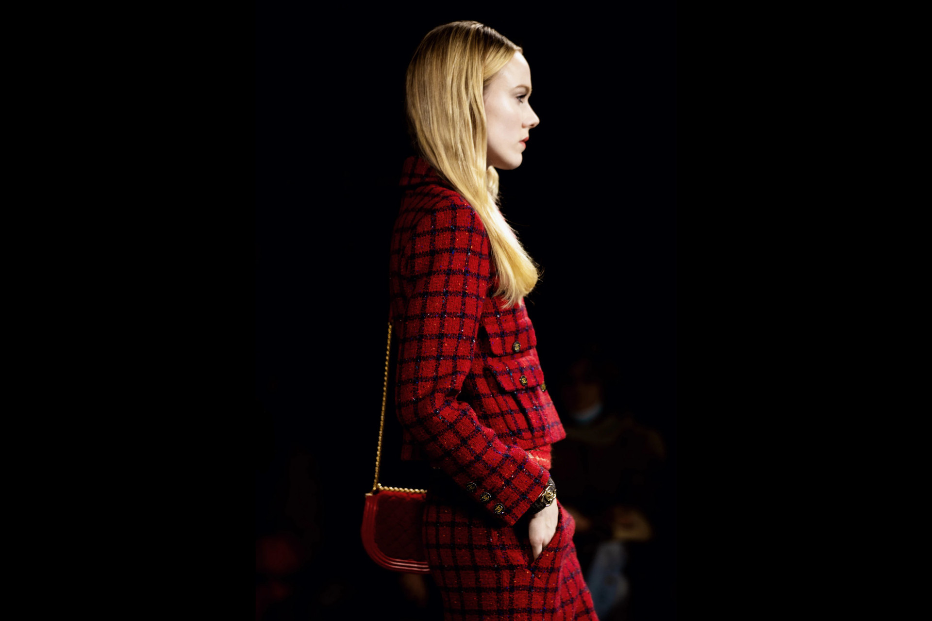 Model in red suit walking the runway