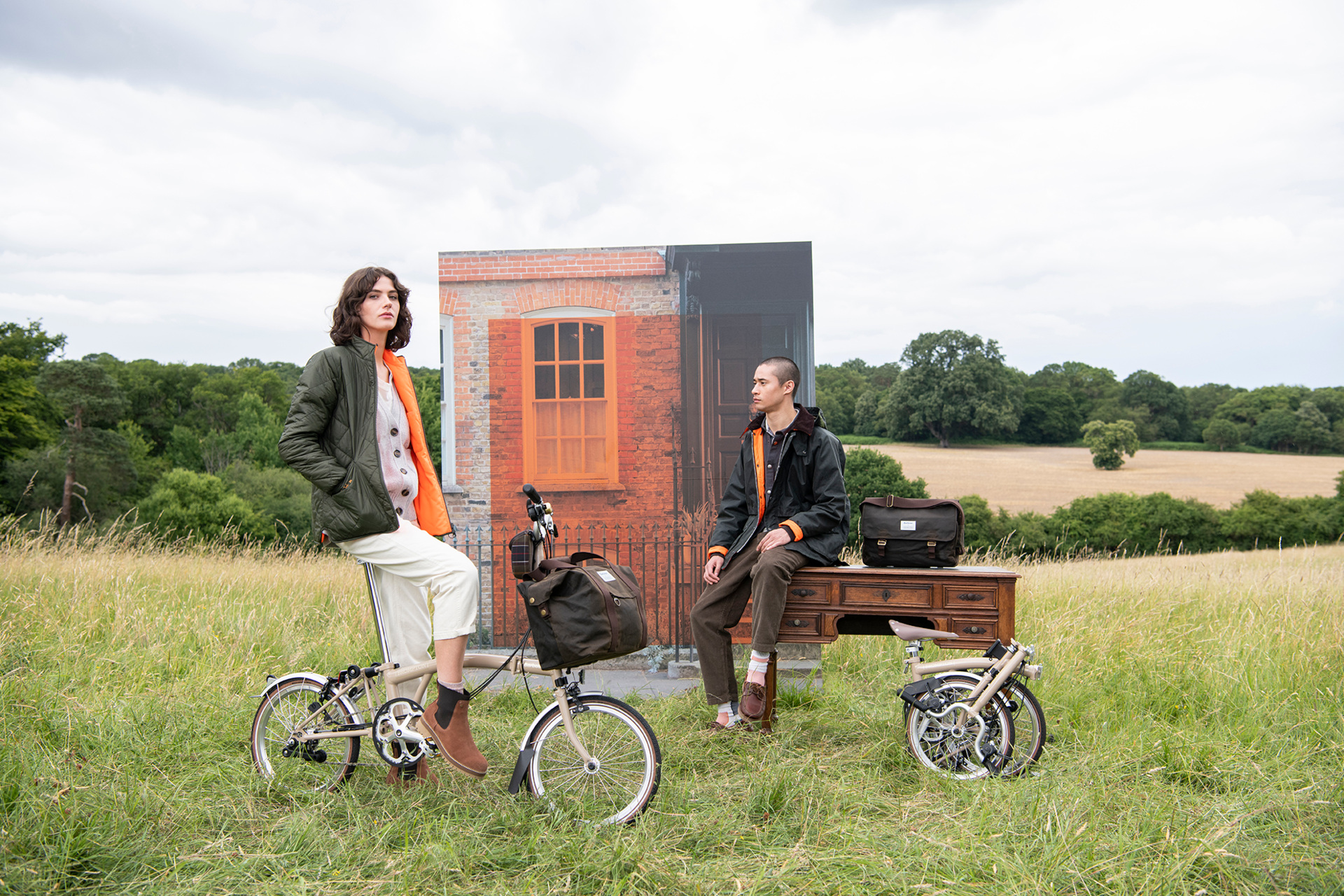 Models sat on bikes in a field