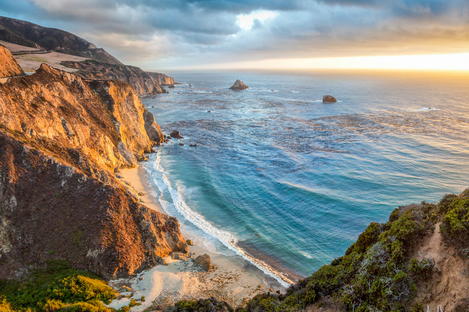 Panoramic view of beautiful Big Sur coastal landscape in beautiful golden evening light at sunset with dramatic clouds in summer, California, Monterey County, USA