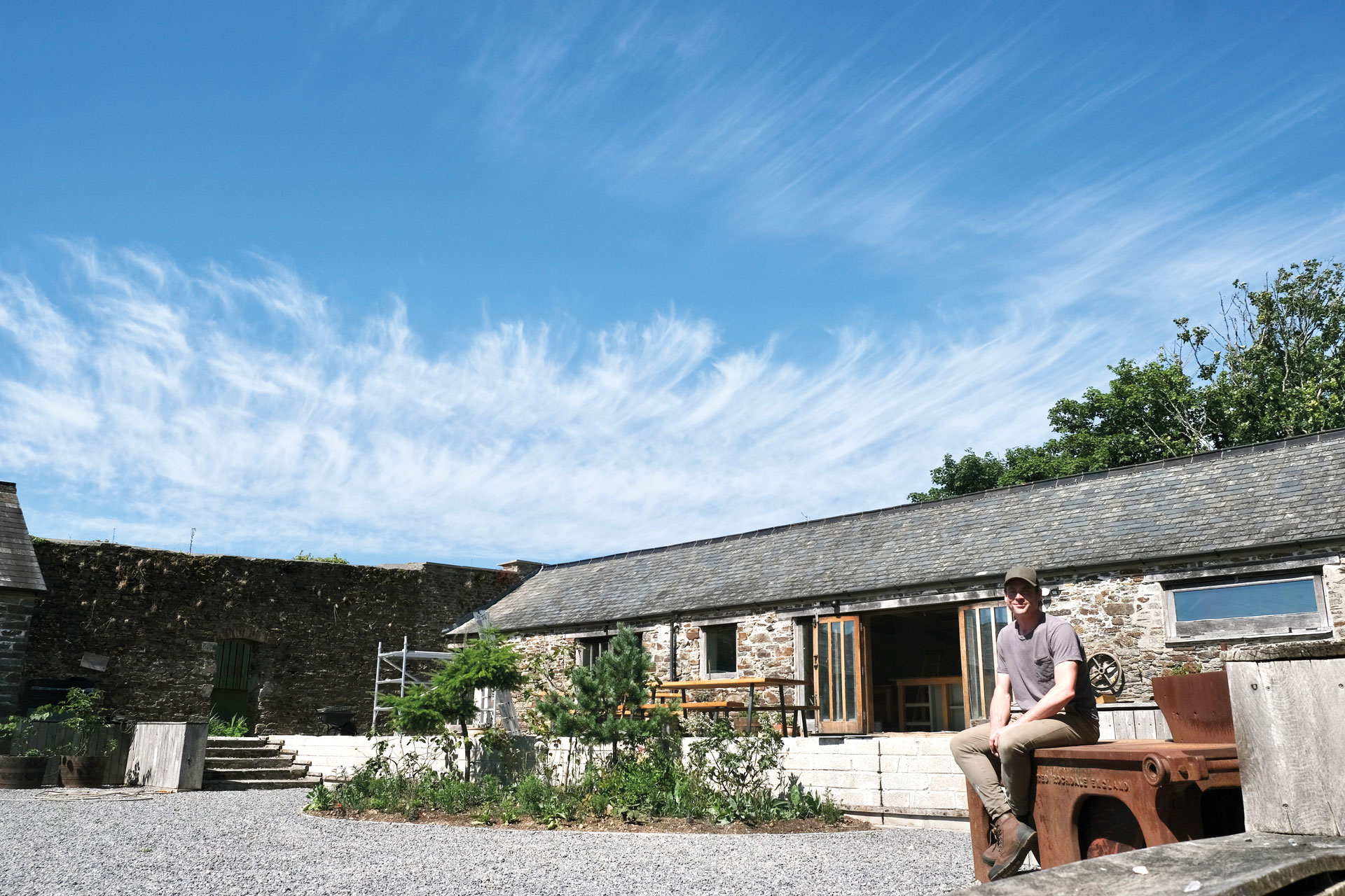 Man sitting outside of barn