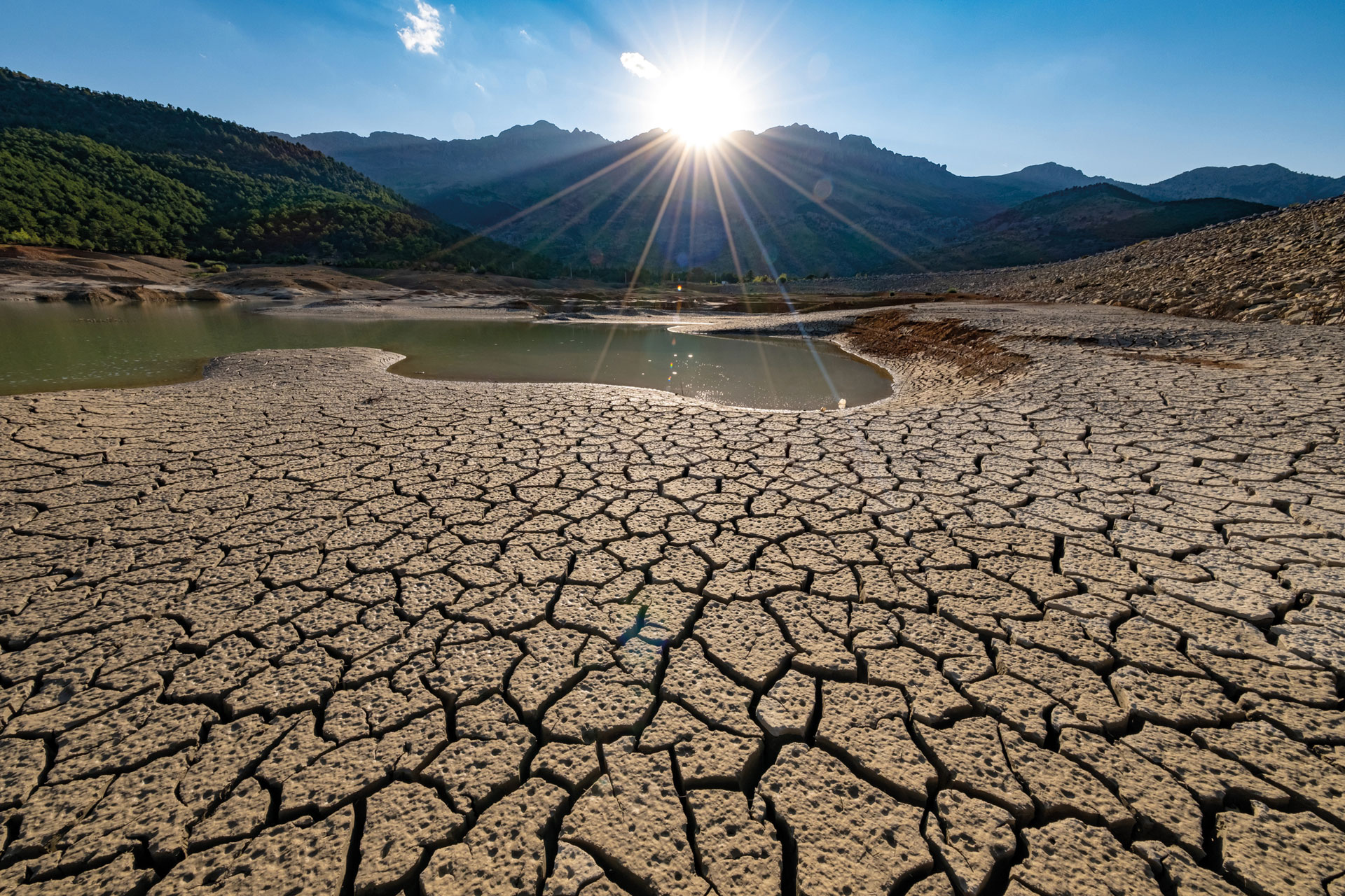 Dry cracked desert with mountains at a distance