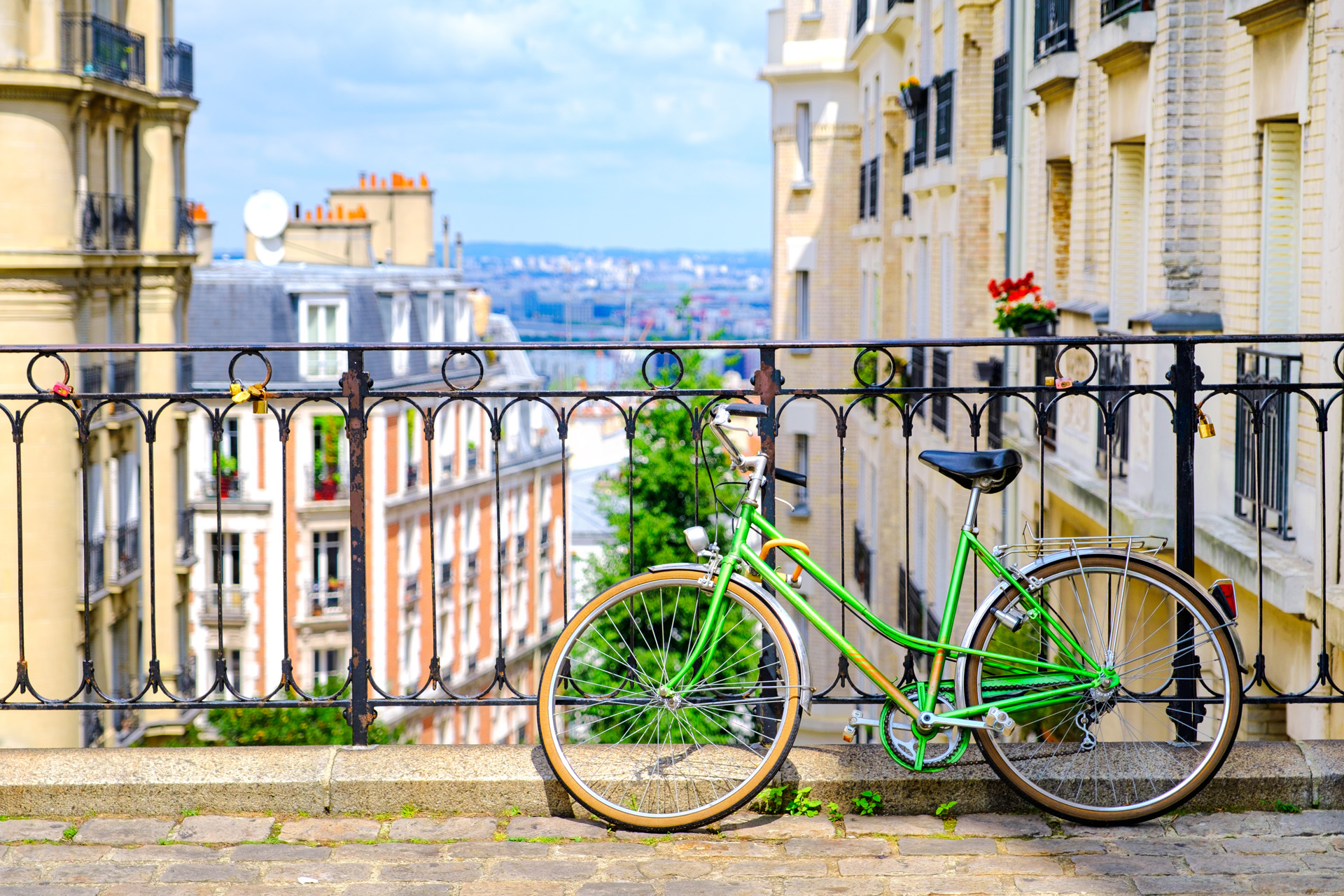 an old green bike standing on the street at the top of Montmartre, Paris, France