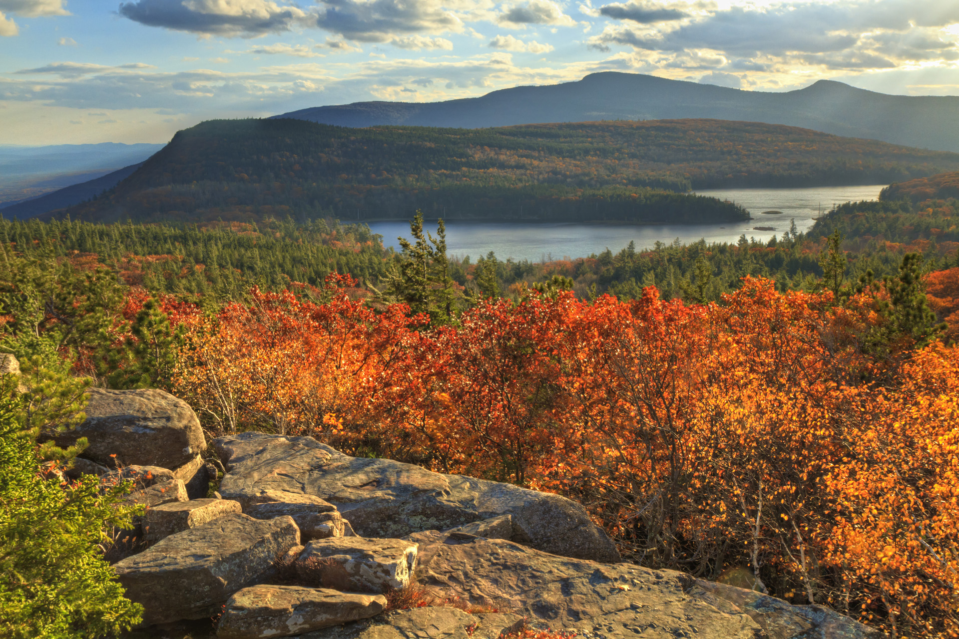"Afternoon sun on sunset rock in the Autumn, overlooking North-South Lake in the Catskills Mountains of New York. (HDR)."