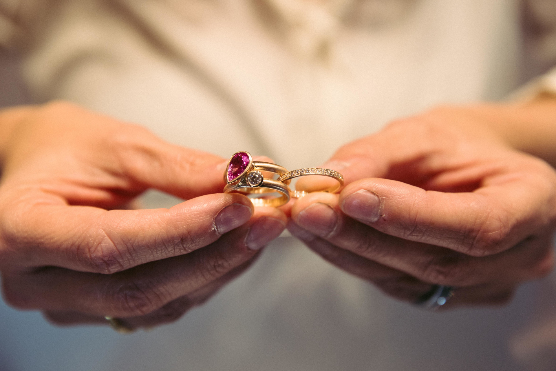 Close up of hands holding gold rings