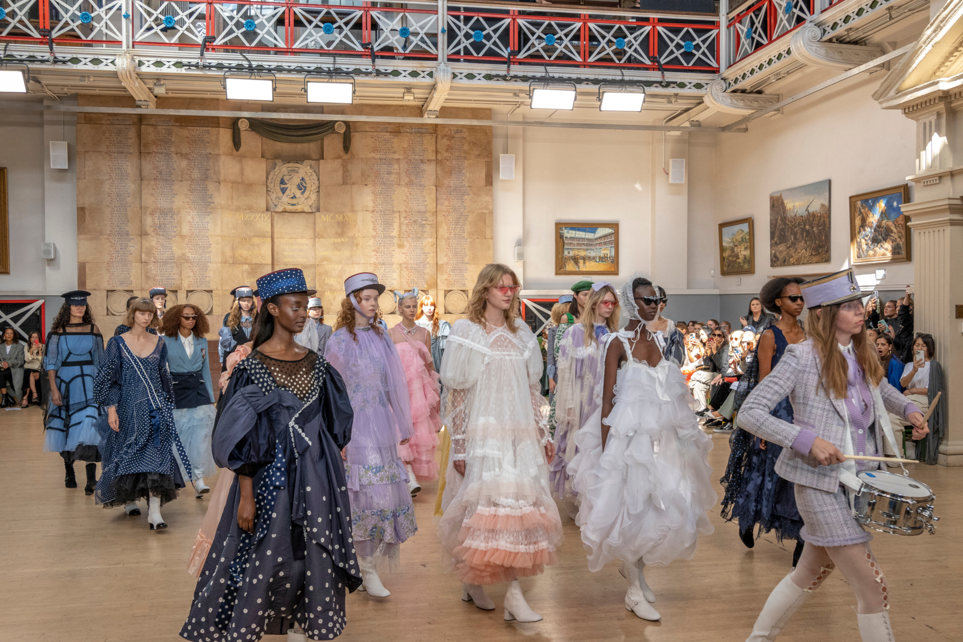 Models walking together off runway