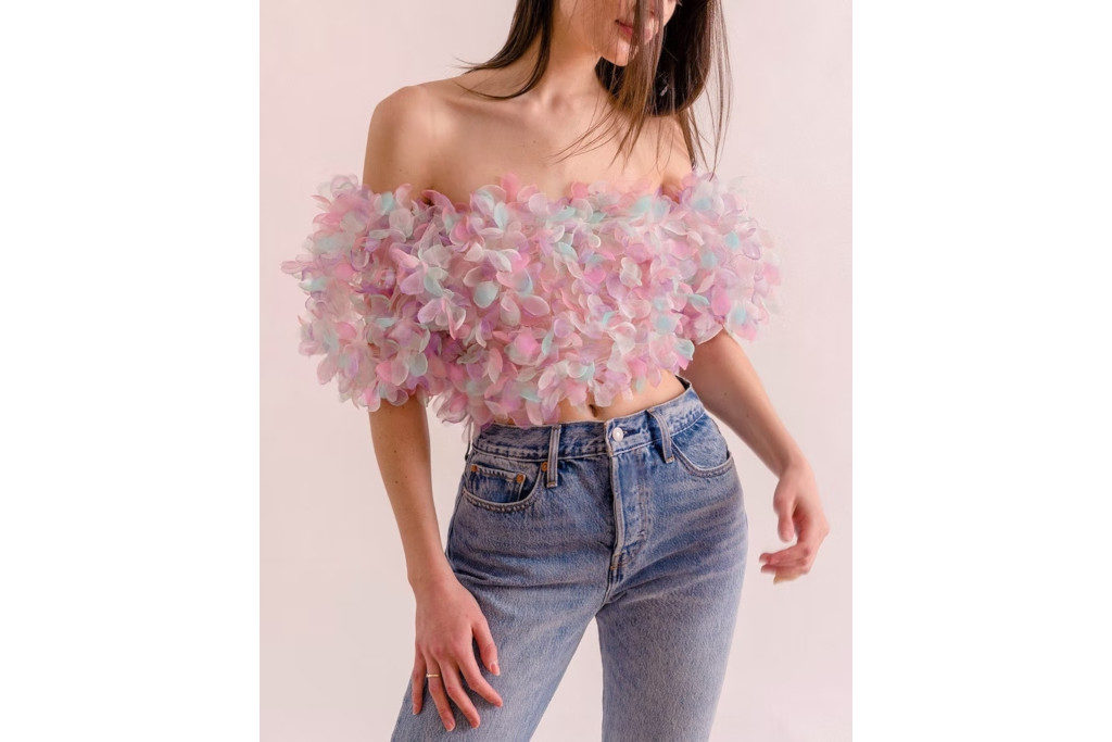 Model wearing pink, blue and purple ruffle crop top and jeans