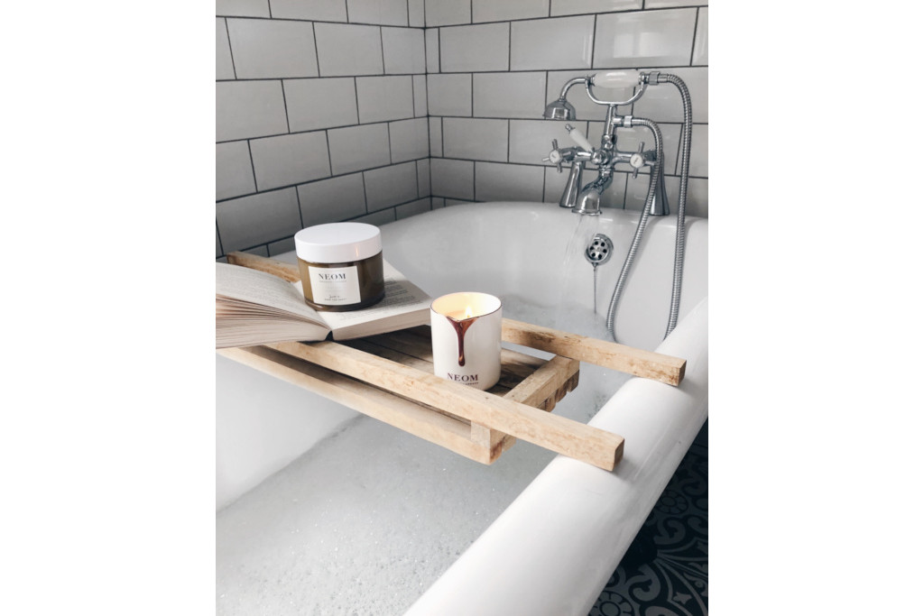 Bath tub with tray of candles on top
