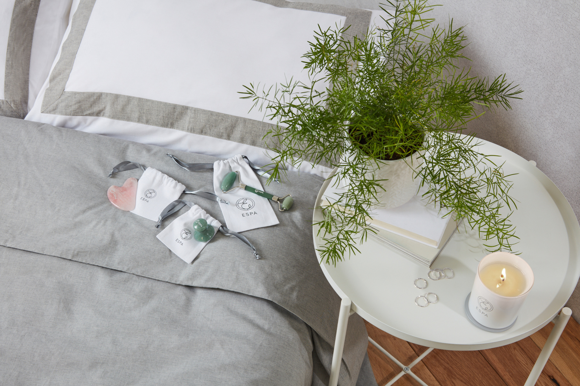 Overhead shot of bed and table with beauty tools