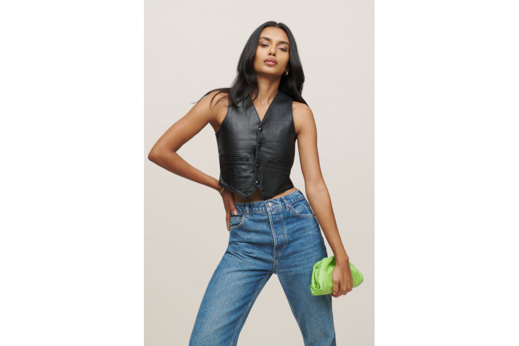 Model in black waistcoat and jeans