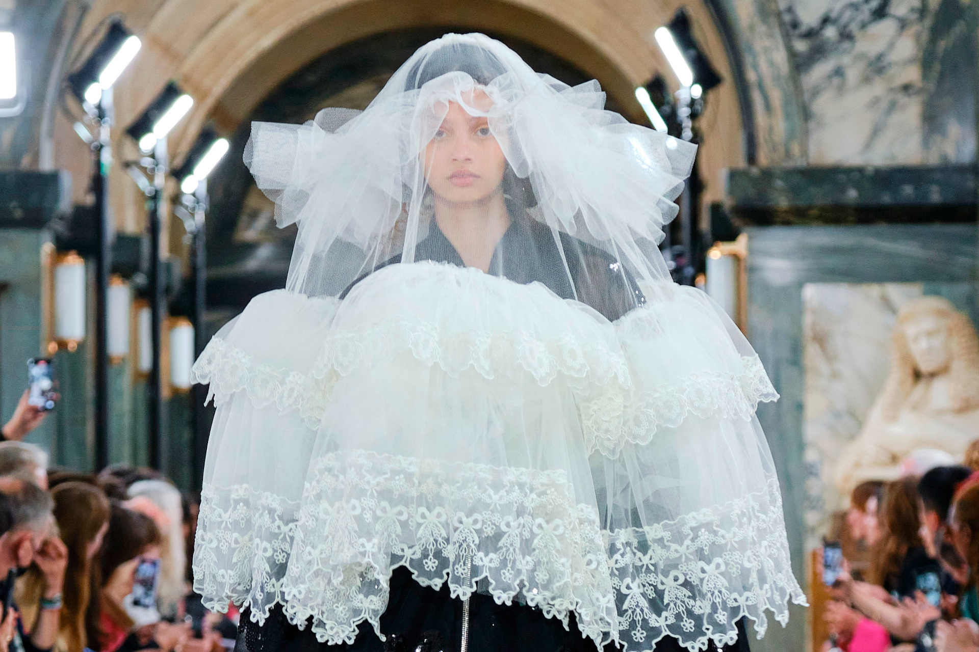 Close up of model wearing a white layered veil
