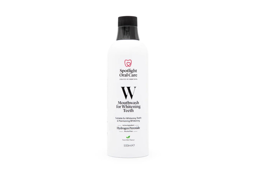 White bottle of mouthwash with black cap