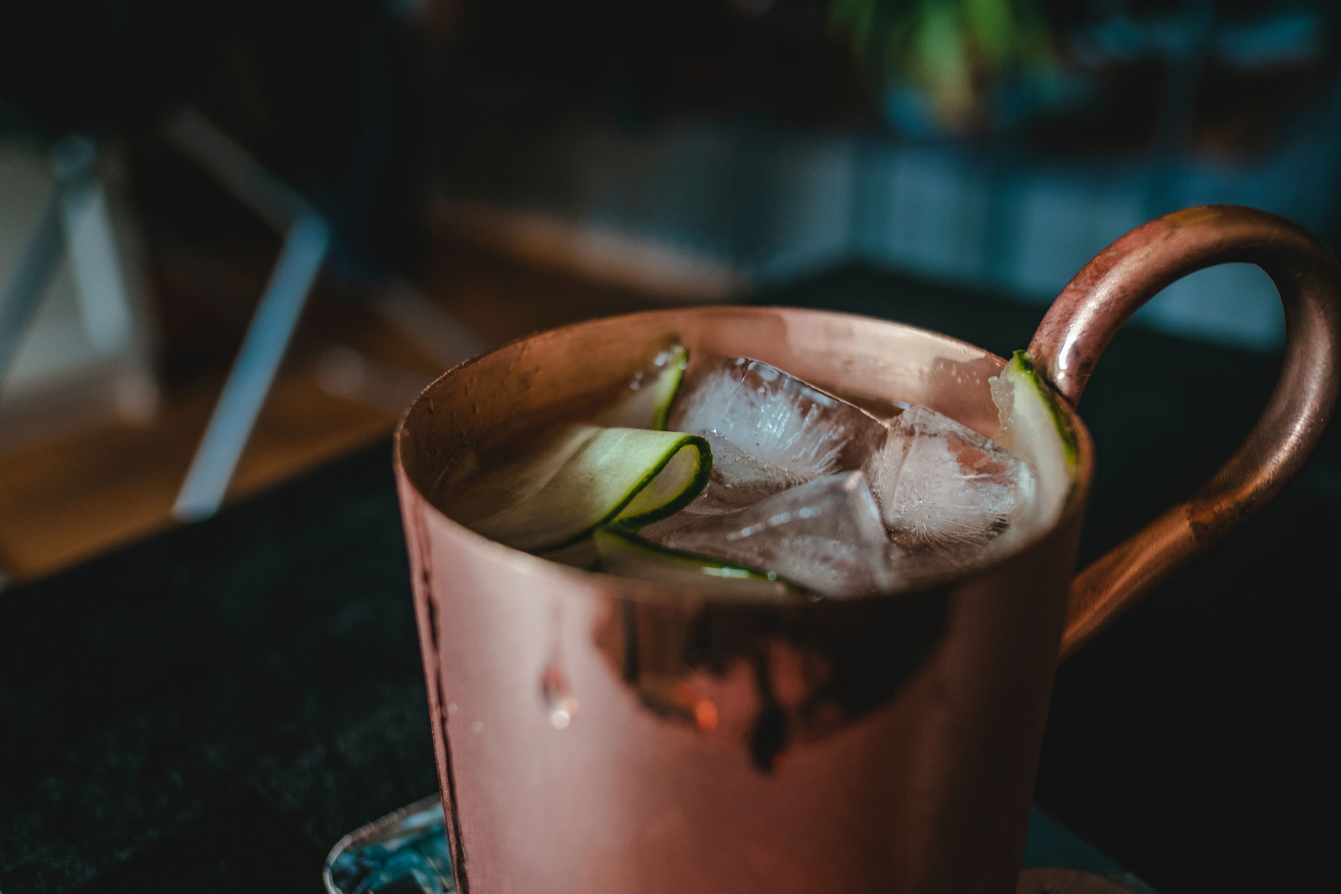 a close up of a moscow mule, in a copper mug, with ice