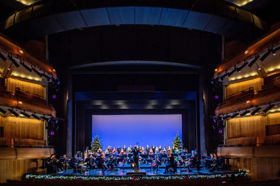 a wide shot of the Glyndebourne Opera House, with a group of musicians playing,