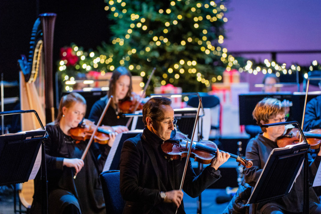 a close up of violinists playing at the Glyndebourne Christmas Concert