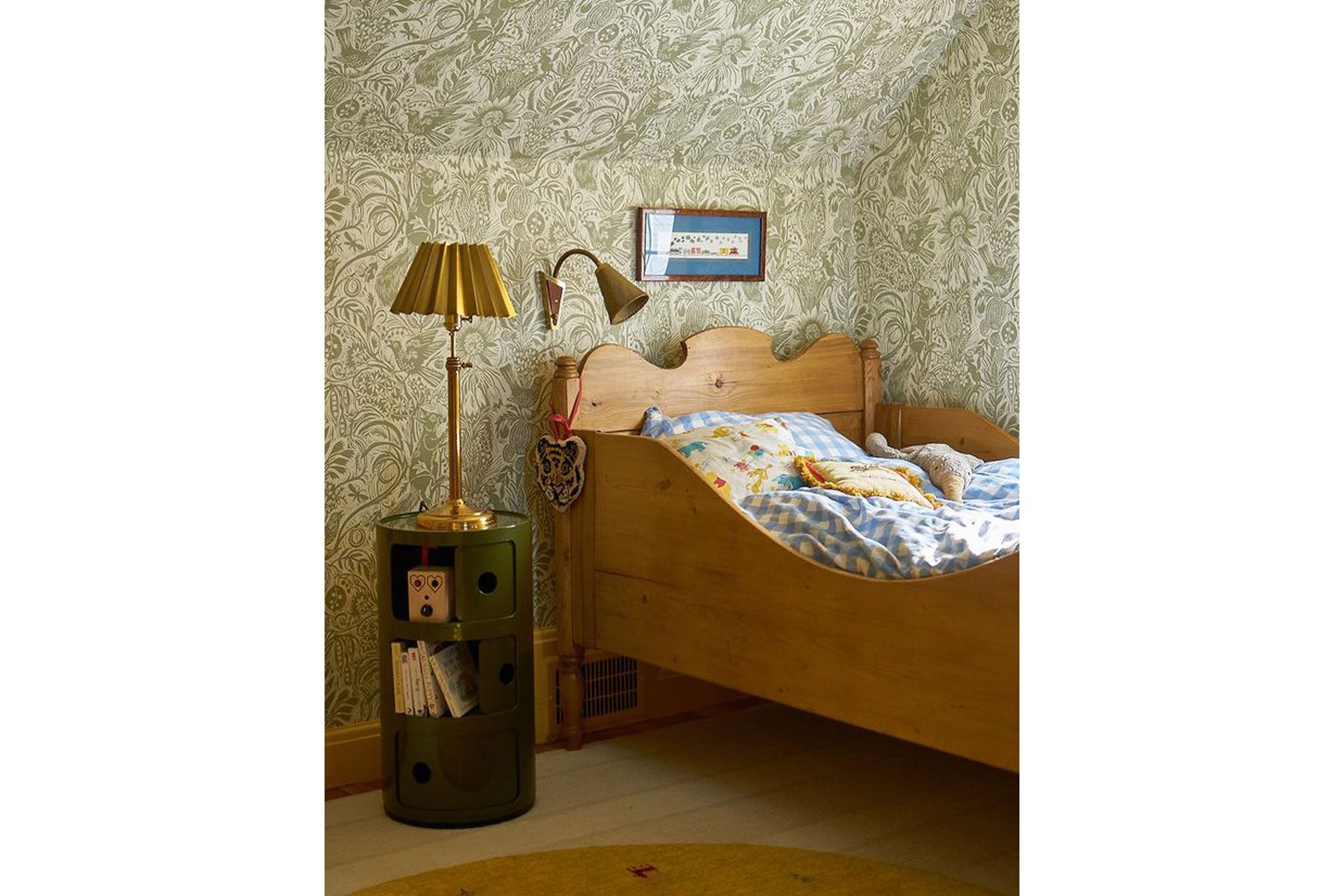 A pine bed by Knosen Antiques, capturing Matilda Goad's night stand and a biophilic wallpaper