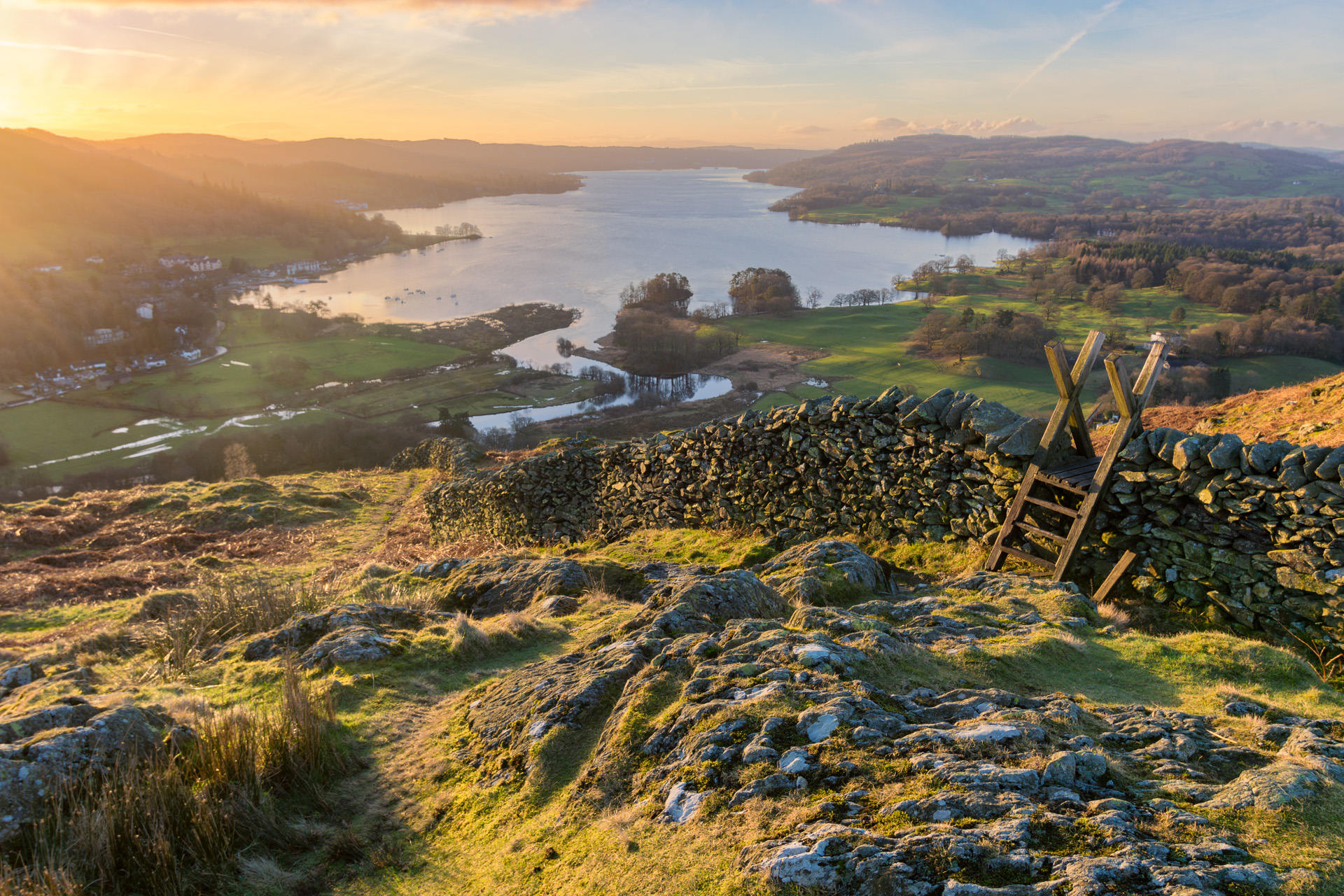 Lake Windermere in the English Lake District taken at sunrise with vibrant colours and golden morning light.