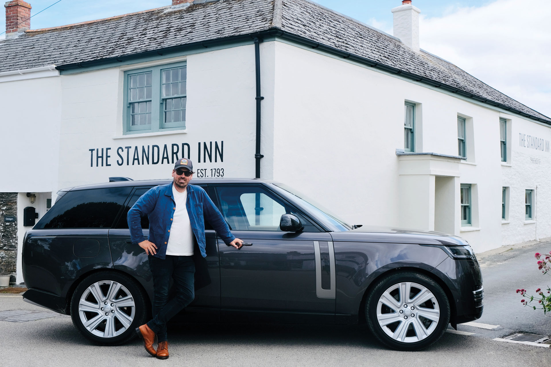 Man standing next to black car